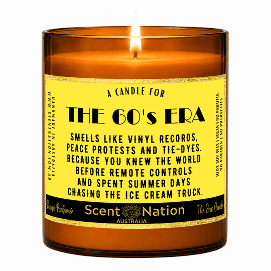 1960s nostalgia gifts – The 60's Era candle: lit Large 285 g soy candle in an amber jar with a gold-trim 'A candle for the 60's era' label, Scent Nation Australia