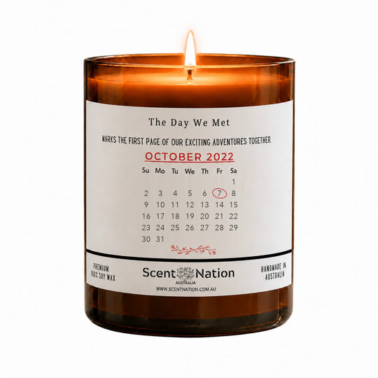 Personalised date anniversary gift – The Day We Met calendar candle: lit Large 285 g amber soy candle with an October 2022 calendar page and the 7th circled in red on a white label, Scent Nation Australia
