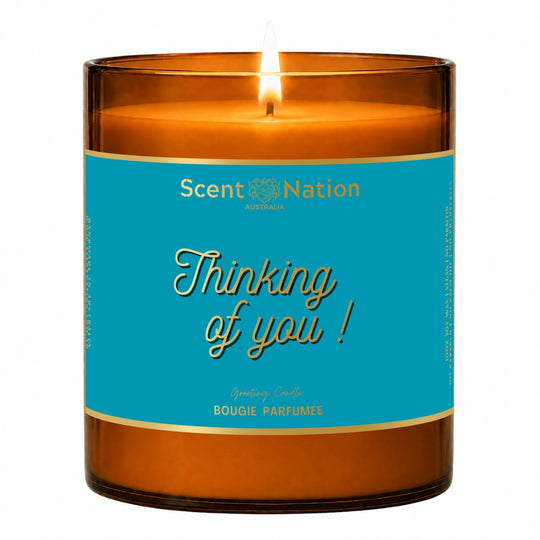 Thinking of you gift – Thinking of You greeting candle: lit Large 285 g amber soy candle with a teal metallic label and gold-foil script, Scent Nation Australia