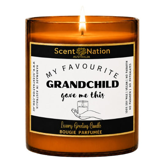 Gifts for grandma: My Favourite Grandchild Gave Me This candle, Large 285g amber soy candle with a black and gold label and a hand holding a candle, Scent Nation Australia