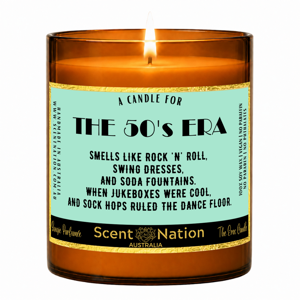 1950s nostalgia gifts – The 50's Era candle: lit Large 285 g soy candle in an amber jar with a gold-trim 'A candle for the 50's era' label, Scent Nation Australia