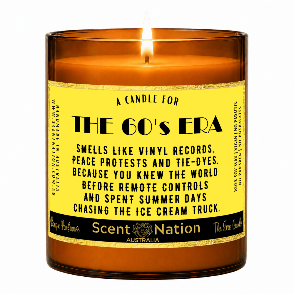 1960s nostalgia gifts – The 60's Era candle: lit Large 285 g soy candle in an amber jar with a gold-trim 'A candle for the 60's era' label, Scent Nation Australia