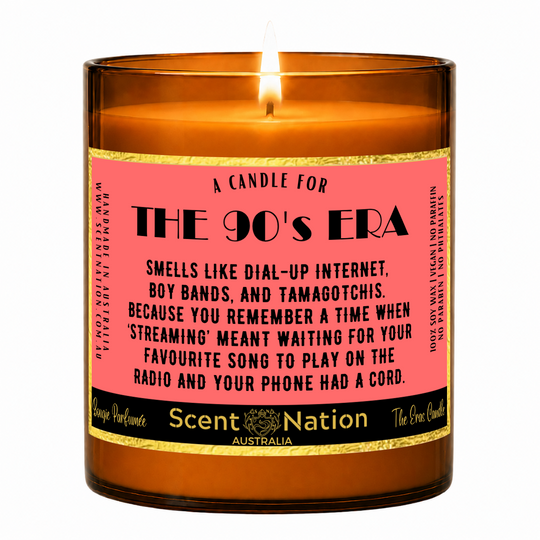 90s nostalgia gifts – The 90's Era candle: lit Large 285 g soy candle in an amber jar with a gold-trim 'A candle for the 90's era' label, Scent Nation Australia