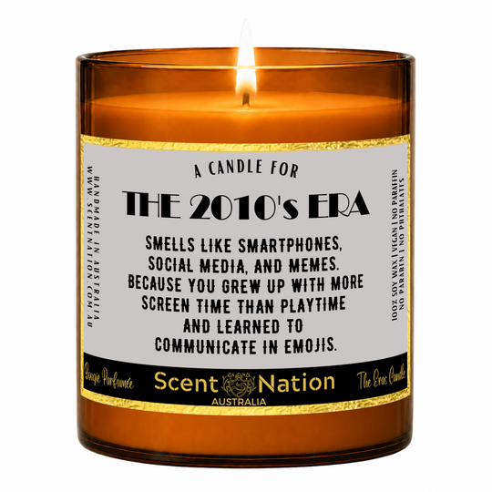 2010s nostalgia gifts – The 2010s Era candle: lit Large 285 g soy candle in an amber jar with a gold-trim 'A candle for the 2010's era' label, Scent Nation Australia