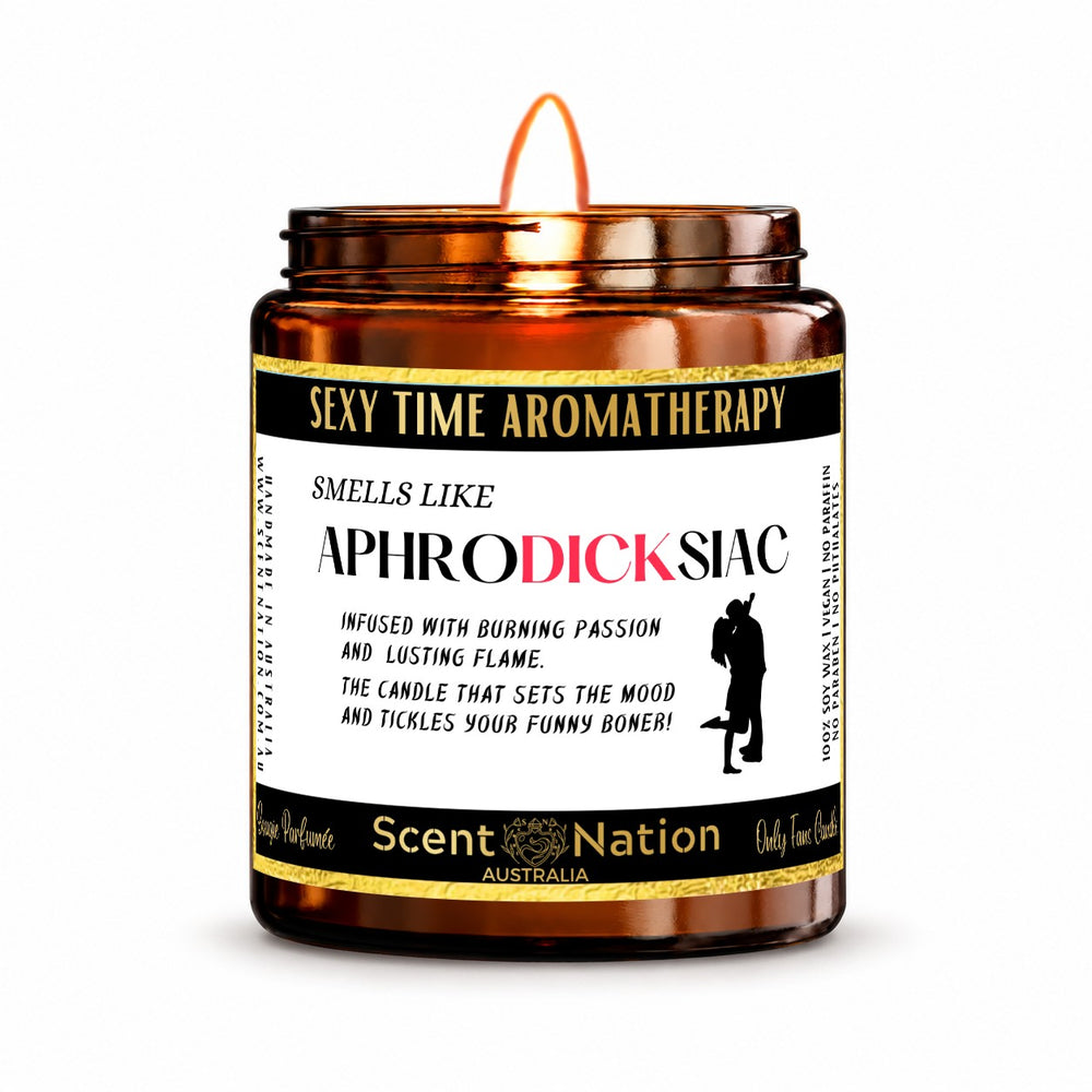 Naughty gift for him – Aphrodicksiac candle: lit Medium 225 g amber soy candle with a Sexy Time Aromatherapy label and gold trim, Scent Nation Australia