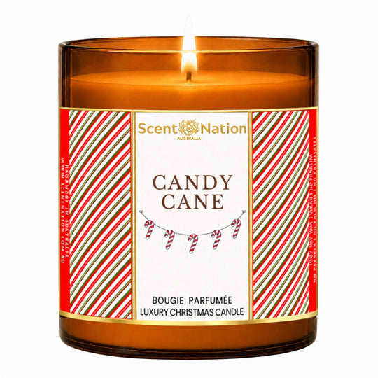 Christmas candle – Candy Cane luxury Christmas candle: lit Large 285 g amber soy candle with a red-and-green candy-stripe label and gold frame, Scent Nation Australia