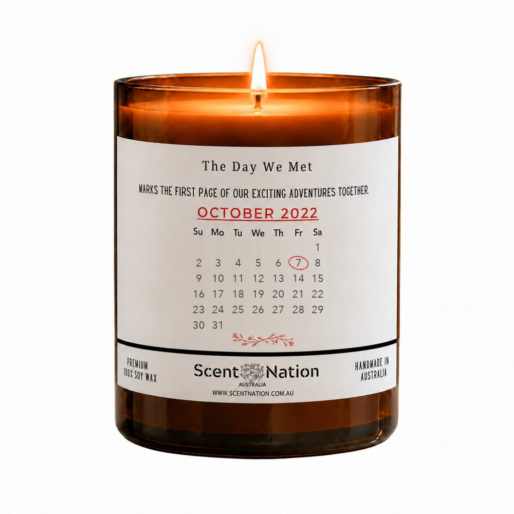 Personalised date anniversary gift – The Day We Met calendar candle: lit Large 285 g amber soy candle with an October 2022 calendar page and the 7th circled in red on a white label, Scent Nation Australia