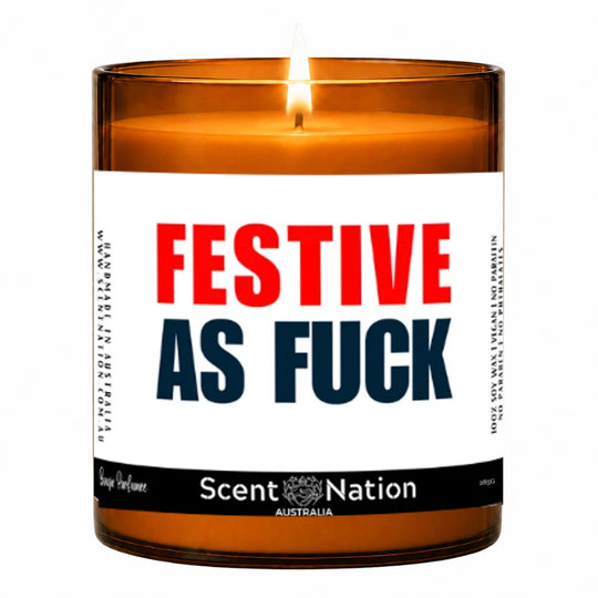 Funny Christmas candle gift – lit Large 285 g amber soy candle with a white label reading Festive As Fuck in red and navy, Scent Nation Australia