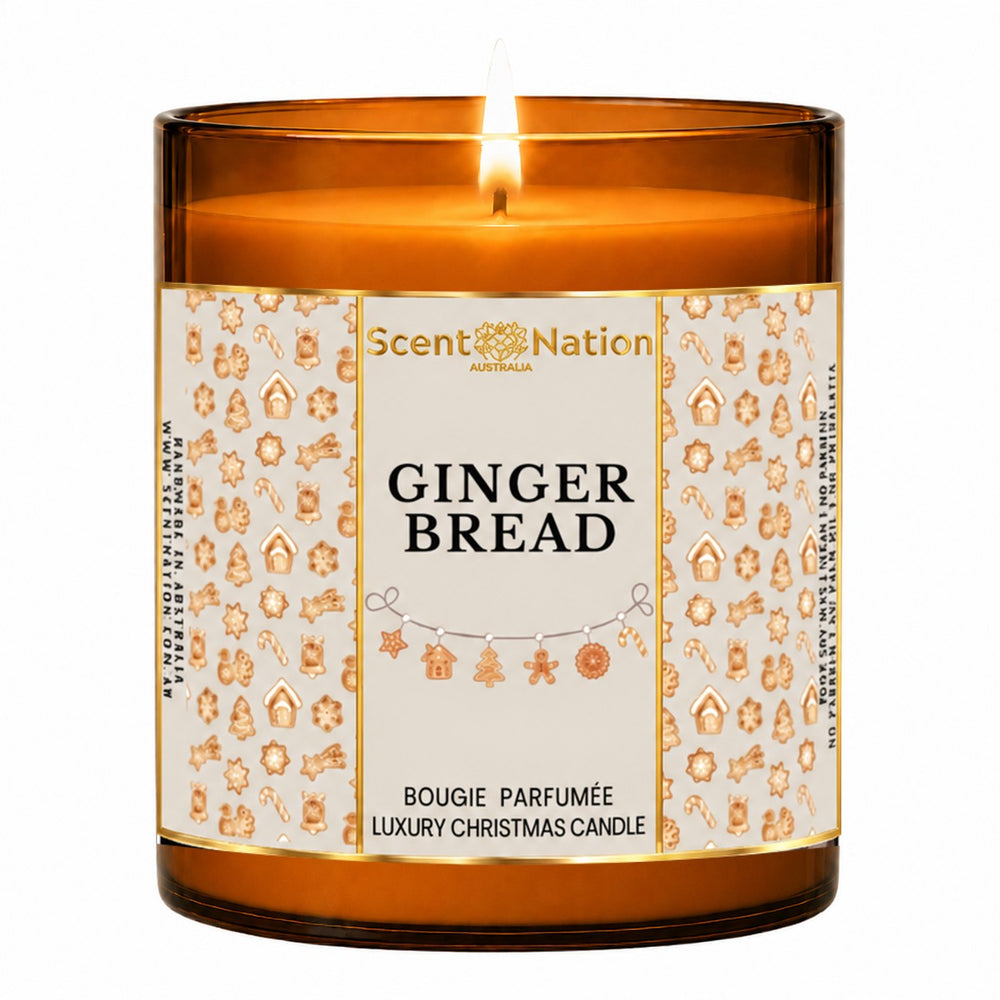 Gingerbread candle – luxury Christmas candle: lit Large 285 g amber soy candle with a gingerbread-cookie pattern label and gold frame, Scent Nation Australia