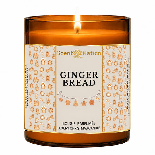 Gingerbread candle – luxury Christmas candle: lit Large 285 g amber soy candle with a gingerbread-cookie pattern label and gold frame, Scent Nation Australia
