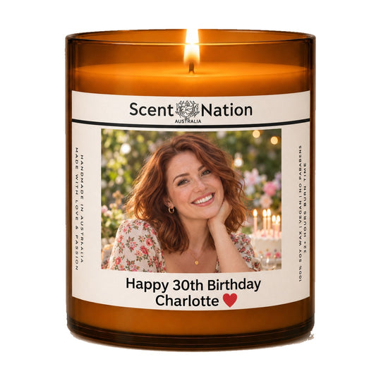 30th birthday gift – personalised 30th birthday photo candle: lit Large 285 g amber soy candle with her photo and 'Happy 30th Birthday Charlotte' on a white label, Scent Nation Australia