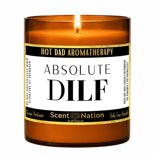Gift for new dads – Absolute DILF candle: lit Large 285 g amber soy candle with a Hot Dad Aromatherapy label and gold trim, Scent Nation Australia