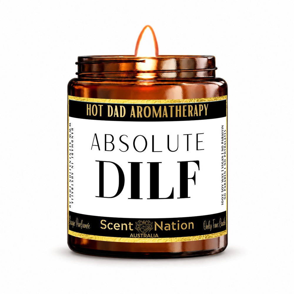 Gift for new dads – Absolute DILF candle: lit Medium 225 g amber soy candle with a Hot Dad Aromatherapy label and gold trim, Scent Nation Australia