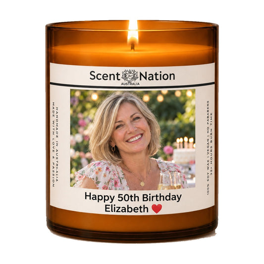 Custom photo candle for milestone birthdays – lit Large 285 g amber soy candle with her photo and 'Happy 50th Birthday Elizabeth' on a white label, Scent Nation Australia