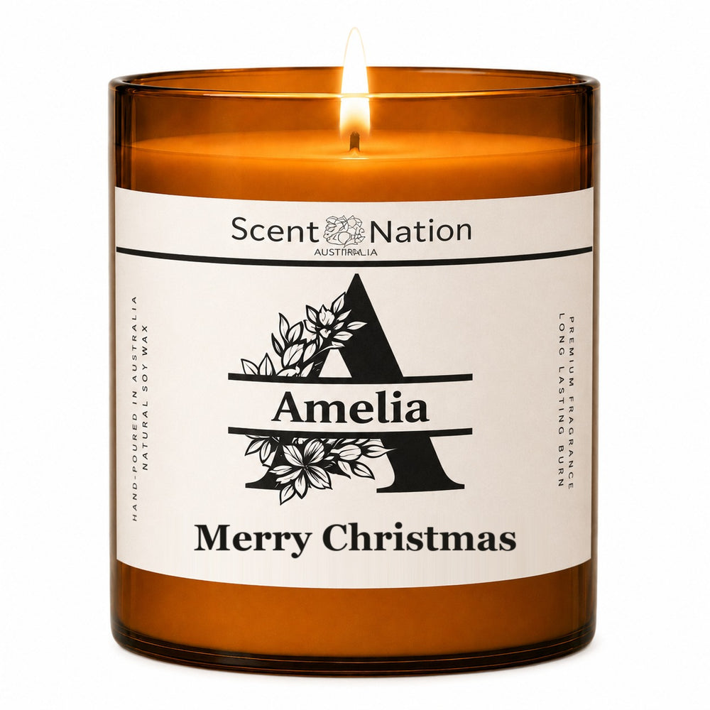 Personalised monogram candle – lit Large 285 g amber soy candle with a botanical initial A, the name Amelia and Merry Christmas on a white label, Scent Nation Australia