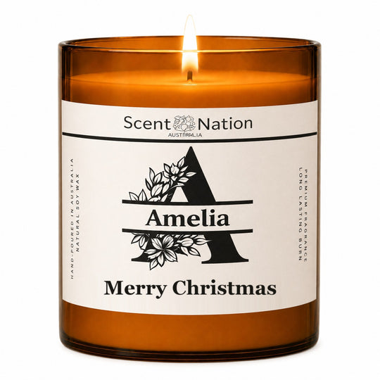 Personalised monogram candle – lit Large 285 g amber soy candle with a botanical initial A, the name Amelia and Merry Christmas on a white label, Scent Nation Australia