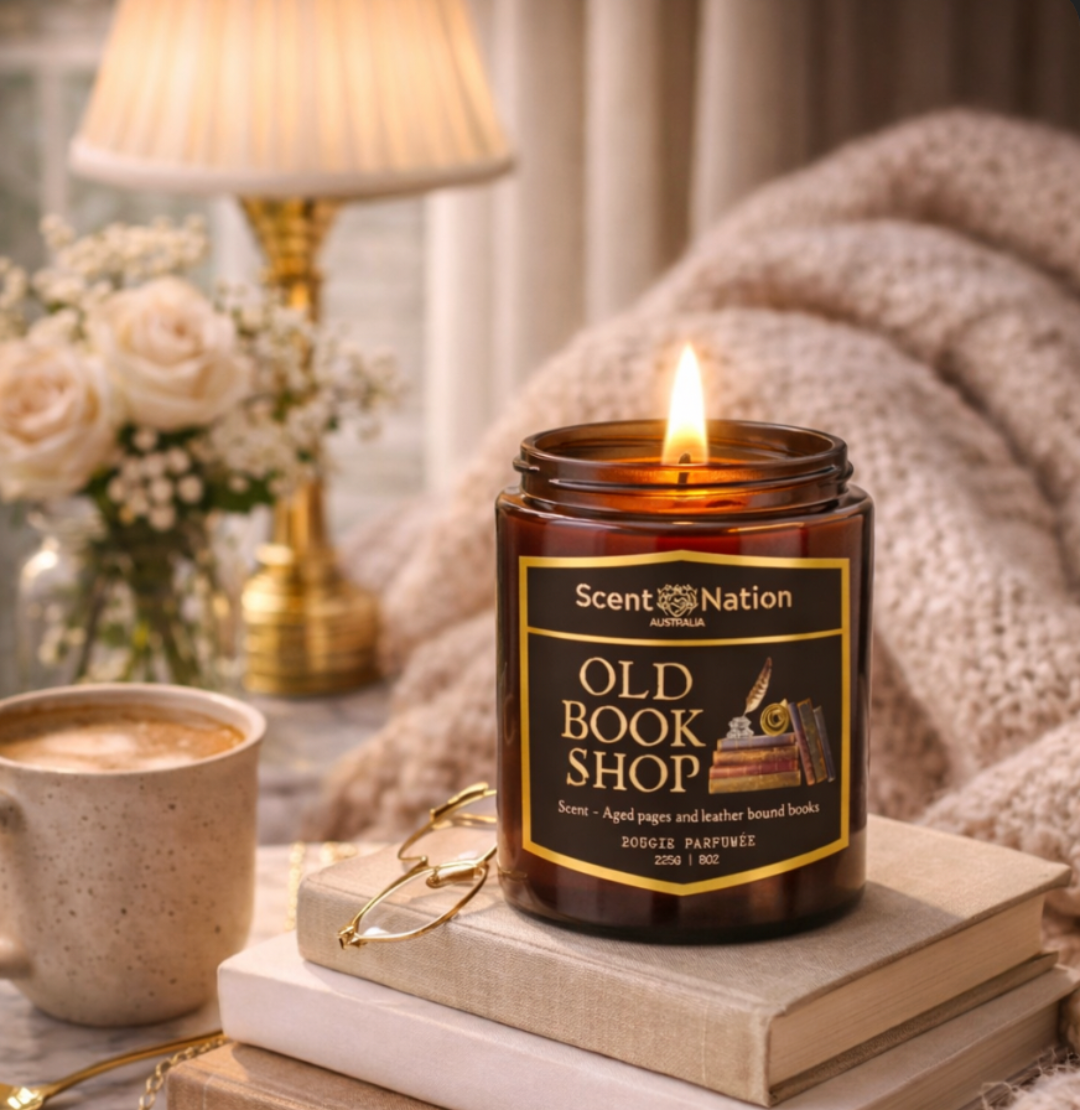 Scented candle labeled 'Old Book Shop' on a stack of books with a cozy background by Scent Nation Australia