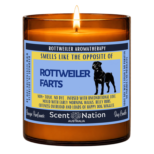 Rottweiler gift – Rottweiler Farts dog fart candle: lit Large 285 g soy candle in an amber jar, blue and yellow ‘Smells like the opposite of Rottweiler farts’ label, Scent Nation Australia