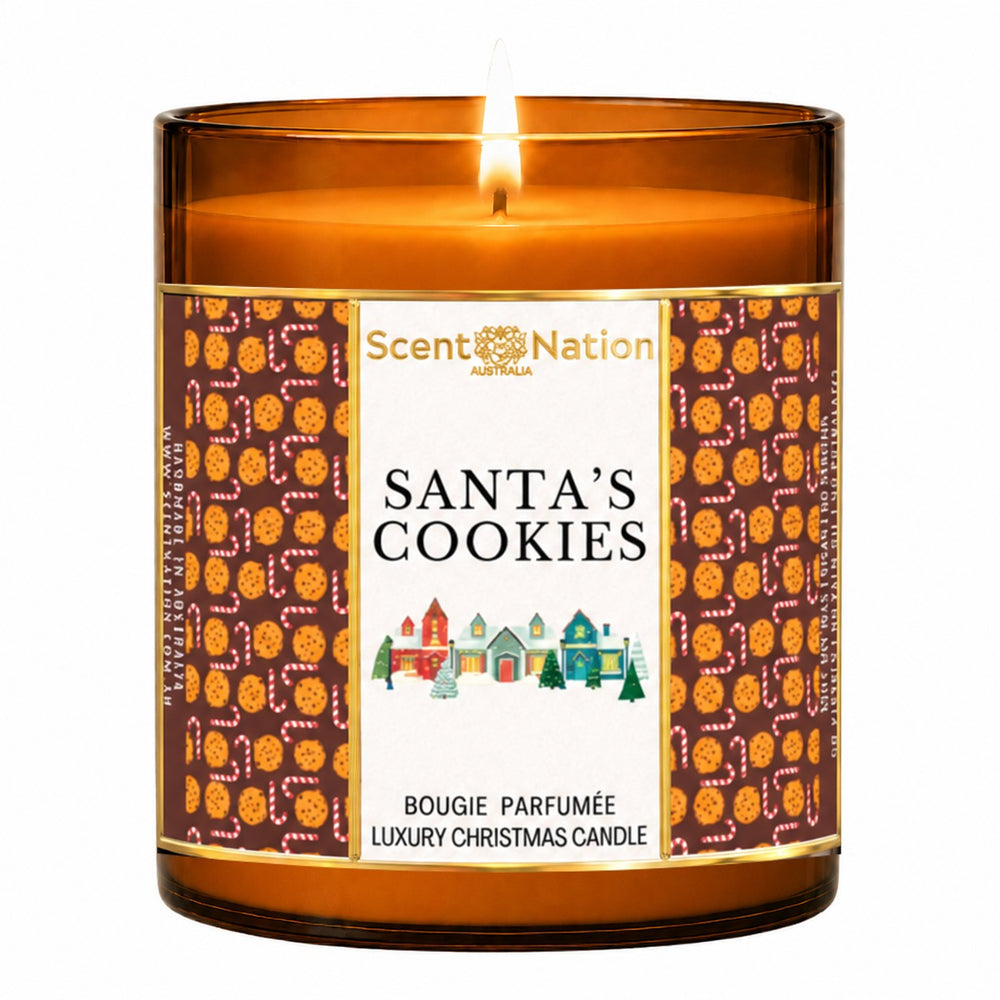 Christmas candle – Santa's Cookies luxury Christmas candle: lit Large 285 g amber soy candle with a cookie-pattern label and Christmas village, Scent Nation Australia