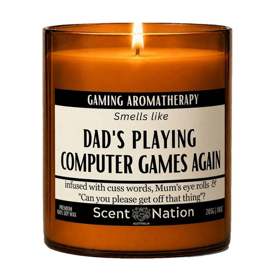Gifts for gamers: Gaming Aromatherapy candle, Large 285g amber soy jar with a cream and black label reading Smells Like Dad's Playing Computer Games Again, Scent Nation Australia