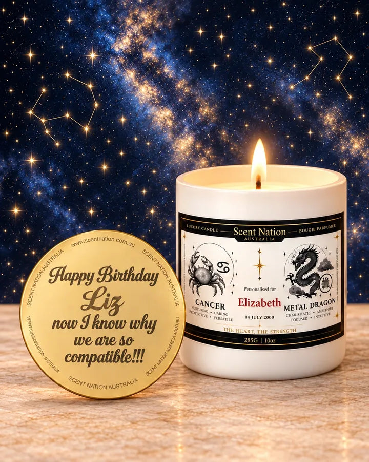 Personalised zodiac birthday candle with engraved lid – Cancer and Metal Dragon Birthdate Story candle for Elizabeth, 14 July 2000, lit under a starry sky beside a gold lid engraved “Happy Birthday Liz”, Scent Nation Australia